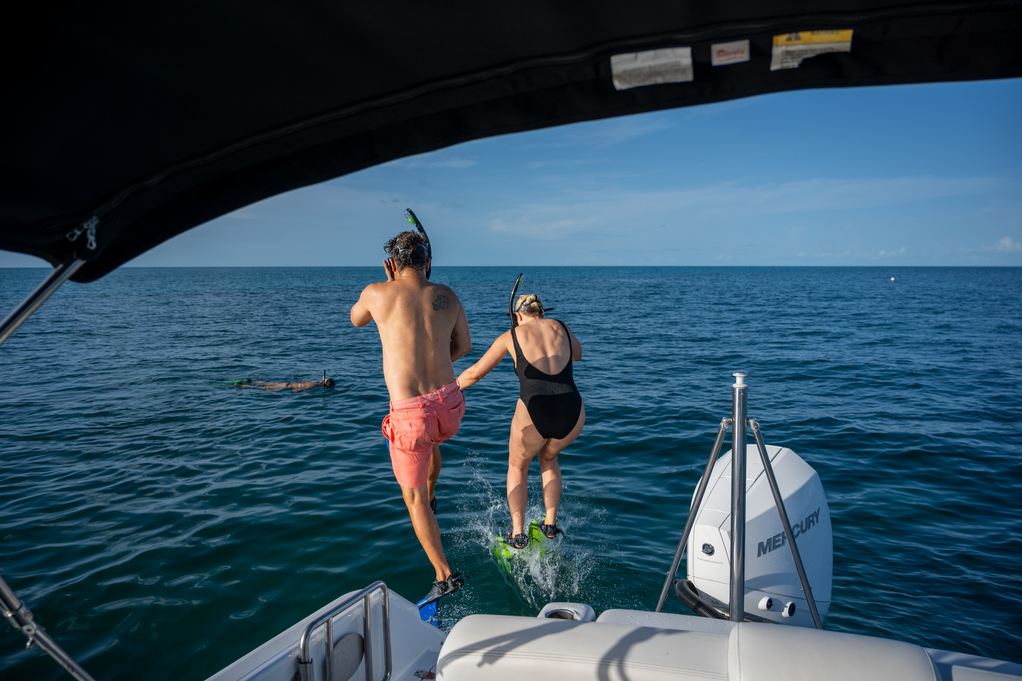 Snorkelers entering the water from a Dolphin Safari Charters boat in Key West